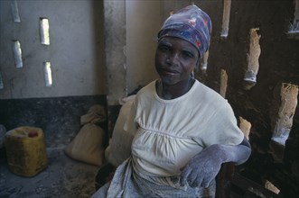 ZAMBIA, Mayukwayukwa Camp, Woman working in maize mill in camp for Angolan refugees with dust from