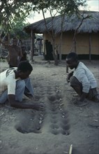 ZAMBIA, Ukwimi Settlement, Mozambique refugees playing game of solo.