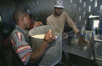 ZAMBIA, Mayukwayukwa Camp, Men working in maize mill in camp for Angolan refugees.