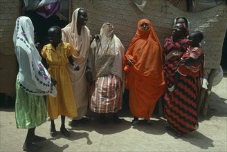 SUDAN, North East, Tokar, Beni Amer Beja nomad women and children wearing colourful clothes.