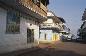 GUINEA BISSAU, Bissau, Quiet street in the commercial area with mural painted on exterior wall of