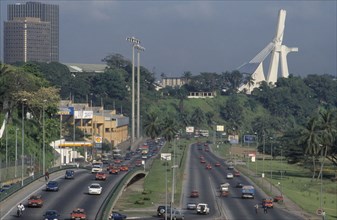IVORY COAST, Abidjan, Cityscape with multi-lane traffic and modern exterior of St Paul’s Cathedral