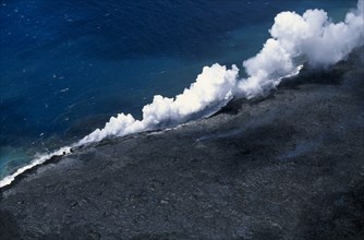 USA, Hawaii, Big Island, Steam rising where lava enters the sea on the south east Puna coast near