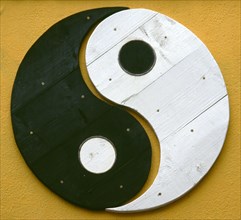 IRELAND, Dublin, "Yin and Yang symbol painted onto a wall. Yin Yang originates in ancient Chinese