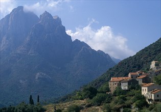 FRANCE, Corsica, The cusp shaped summit of Capo D’Orto provides a dramatic backdrop to the hillside
