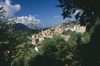 FRANCE, Corsica, "Morning in the hillside village of Evisa, with cumulus clouds crowning Capo