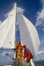 ENGLAND, Dorset, Lymington, Female crew on yacht preparing for trans-Atlantic race.