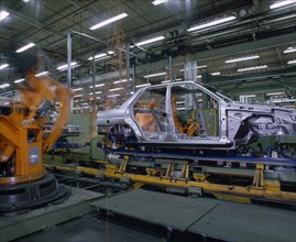 INDUSTRY, Cars, Ford Orion Car Production. Interior of factory with the shell of a silver car on