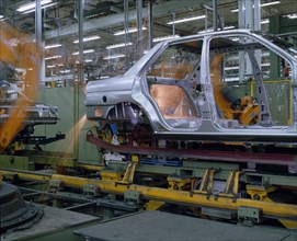 INDUSTRY, Cars, Ford Orion Car Production. Interior of factory with the shell of a silver car on