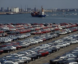 INDUSTRY, Cars, Southampton Docks. Rows of imported cars with container ships and boats on the