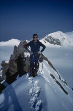 INDIA, Himalayas, Climber on snow covered summit.