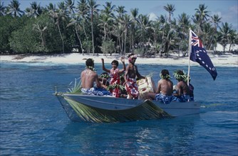 PACIFIC ISLANDS, Polynesia, Cook Islands, Manihiki Island. People traveling on boat welcoming
