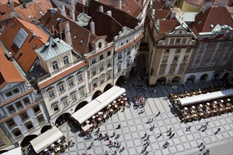 CZECH REPUBLIC, Bohemia, Prague, Restaurant and cafe tables with strolling pedestrians in the Old