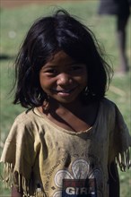 MADAGASCAR, Peope, Children, Portrait of a smiling child wearing a dirty t shirt printed with the