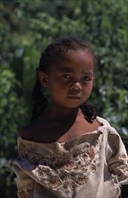 MADAGASCAR, People, Children, Road to Ambalavao. Portrait of a young girl wearing pig tails in her