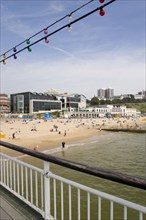 ENGLAND, Dorset, Bournemouth, The East Beach from the pier with seafront restaurants and bars.