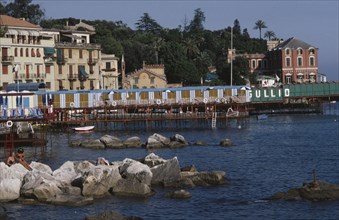 ITALY, Liguria, Rapallo, Coastal town on the Italian Riviera with line of changing huts on jetty
