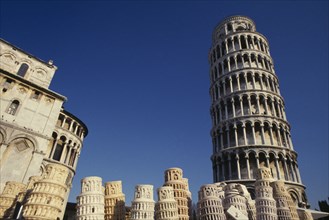 ITALY, Tuscany, Pisa, The Leaning Tower with souvenir models displayed in foreground.