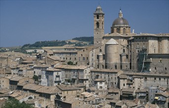 ITALY, Marche, Urbino, Palazzo Ducale rising above city rooftops.  Built for Duke Federico da