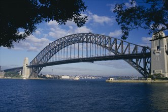 AUSTRALIA, New South Wales, Sydney, The Harbour Bridge framed by silhouetted trees.
