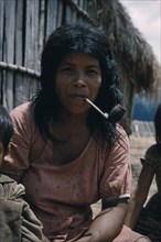 COLOMBIA, Sierra de Perija, Yuko - Motilon , Mother smoking tobacco in a clay pipe