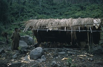 COLOMBIA, Sierra de Perija, Yuko - Motilon, "Palm thatch dwellings and shelters, boy wearing long