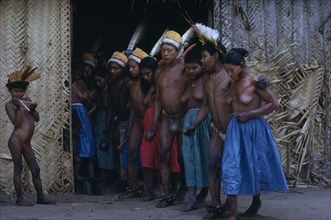 COLOMBIA, Vaupes Region, Tukano Tribe, "Men and women emerge from maloca dancing the Manioc Dance,