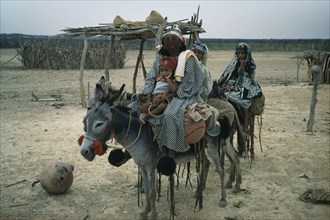COLOMBIA, Guajira Peninsula, Guajiro / Wayuu Tribe, "Mother and daughters on donkeys, normal means