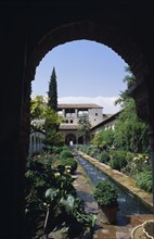 SPAIN, Andalucia, Granada, The Generalife.  Long central pool in the Patio de la Acequia enclosed