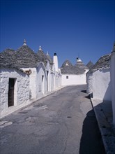 ITALY, Puglia, Bari, "White Trulli buildings with grey stone roofs in Alberobello village that have