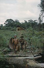 COLOMBIA, Vaupes Region, Tukano Tribe, "Headman with yucca flour basket, his brother with fishing