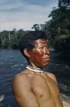 COLOMBIA, Vaupes Region, Tukano Tribe, "Portrait of Marco, a hunter with red “karajuru” facial
