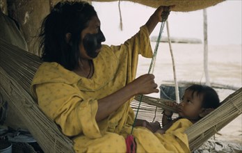 COLOMBIA, Guajira Peninsula, Guajiro / Wayuu Tribe, Mother and baby son in a “fique” / cactus fibre