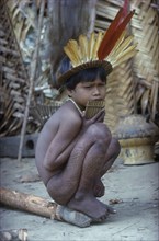 COLOMBIA, Vaupes Region, Tukano Tribe, "Young boy with “we” dark purple leaf dye and a crown of