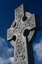 SCOTLAND, Scottish Borders, Melrose , Melrose Abbey. Celtic cross against a blue sky.