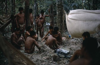 COLOMBIA, Llanos Plains, Agua Clara, "Cuiva: First Contact with Agua Clara  group of men listening