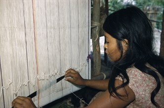 COLOMBIA, Sierra de Perija, Yuko-Motilon, Girl weaving cotton “manta”  / cloak at a Yuko - Motilon