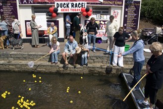 ENGLAND, Dorset, Bournemouth, Traditional Duck Race in The Lower Pleasure Gardens with tourists