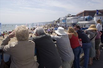 ENGLAND, Dorset, Bournemouth, Tourists watching speedboat races off the West Beach with the