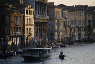 ITALY, Veneto, Venice, Crowded vaporetto or waterbus and gondola on the Grand Canal near Rialto