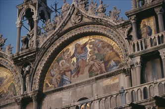 ITALY, Veneto, Venice, St Marks Square.  Detail of mosaic and carvings on exterior facade of