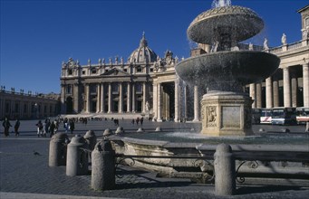 ITALY, Lazio, Rome, St Peter’s exterior with fountain in foreground.