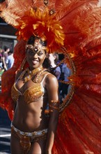 ENGLAND, London, Notting Hill carnival female reveller in extravagant costume