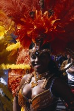ENGLAND, London, Notting Hill carnival female reveller in extravagant costume