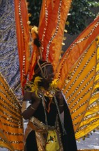 ENGLAND, London, Notting Hill carnival woman in extravagant costume.