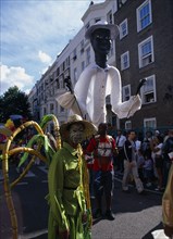 ENGLAND, London, Notting Hill carnival reveller in extravagant costume.