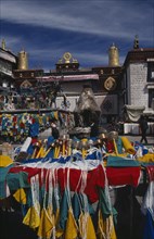 CHINA, Tibet, Lhasa, Prayer wheels and other religious paraphernalia for sale in front of the