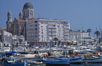 FRANCE, Alpes Maritimes, St Raphael, Town buildings and port with yachts moored on water