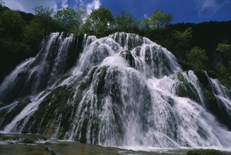 FRANCE, Franche Comte, Ciaquc de Baume, Jura. Waterfall cascading over rocks