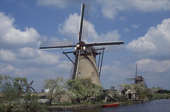 HOLLAND, Zuid Holland, Kinderdijk, Windmill seen from across water
